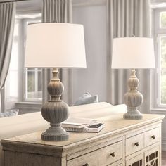 a living room with two lamps on top of a table