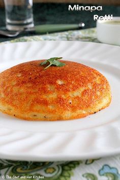 a white plate topped with a piece of food on top of a green table cloth