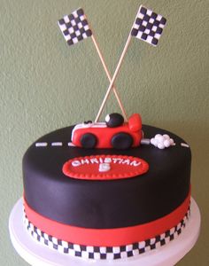 a birthday cake with cars and checkered flags on top