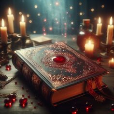 an old book with a red heart on it surrounded by candles and other items in the background