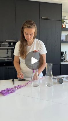 a woman is making something with purple paint