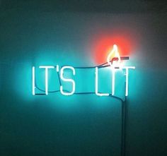 a neon sign that says it's lit up on the side of a wall