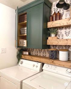 a washer and dryer in a small room with shelves above the washer