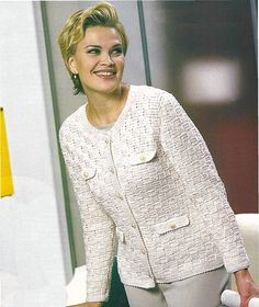 a woman in white jacket and pants posing for the camera