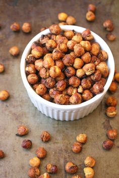 a white bowl filled with nuts on top of a table