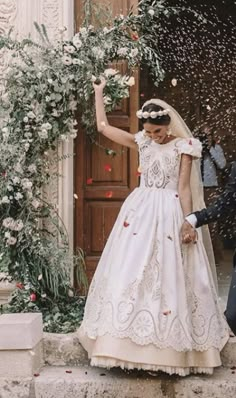 a bride and groom are throwing confetti at each other in front of a doorway