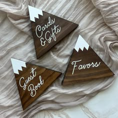 three wooden coasters with the words cards and gifts written on them in white ink