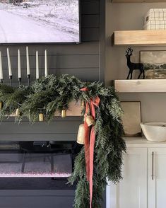 a christmas wreath is hanging on the mantle