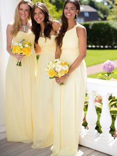 three beautiful young women standing next to each other on a porch holding bouquets in their hands