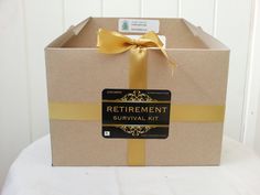 a brown box with a yellow ribbon and a tag on the front that says retirement survival kit