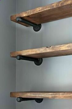 three wooden shelves with black pipe handles