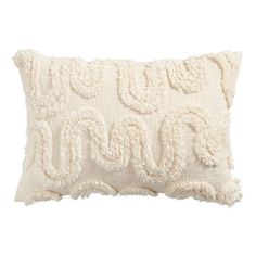 an embroidered pillow with the word love on it in white and cream colors, sitting on top of a white background