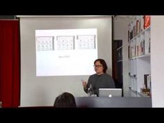 a woman standing in front of a whiteboard giving a presentation