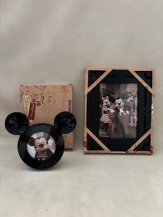 a mickey mouse photo frame next to a box with an image of minnie on it