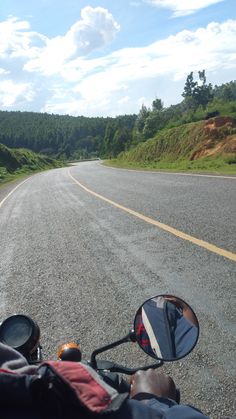 a person riding a motorcycle down a curvy road