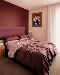 a bedroom with a bed, dresser and large window in it's center area