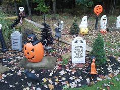 halloween decorations in the yard with pumpkins and jack - o'- lantern heads