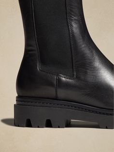 Black High-top Chelsea Boots In Calf Leather, Calf Leather Boots With Lug Sole, Medium Width, Black Mid-calf Calf-leather Boots With Lug Sole, Classic Black Ankle-high Chelsea Boots, Luxury Ankle-high Chelsea Boots With Lug Sole, City Streets