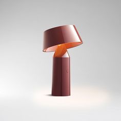 an orange lamp sitting on top of a table