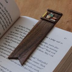 an open book with a miniature wooden cross on it