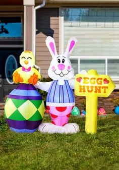 an inflatable easter egg hunt sign and bunny statue