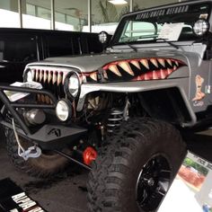 a jeep with an animal - like design on the front and back bumper is displayed