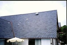 an umbrella is on the roof of a house