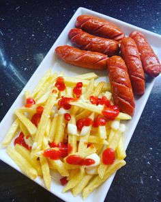 two hot dogs and french fries on a plate