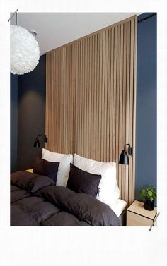 an image of a bedroom setting with wood slats on the wall and bedding