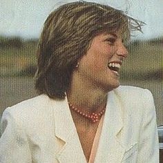 an old photo of a woman smiling and wearing a white suit