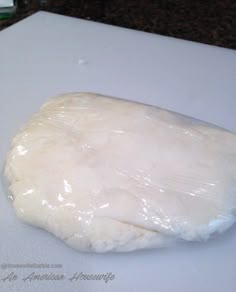 a large piece of dough sitting on top of a cutting board