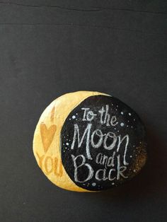 a painted rock that says to the moon and back