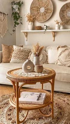 a living room with wicker furniture and baskets hanging on the wall above the couch