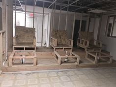 an unfinished room with wooden chairs and plywood flooring on the ground in front of it