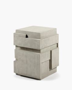 a concrete box with two drawers on the front and one drawer open to reveal something