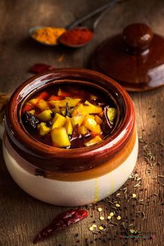 a wooden bowl filled with food on top of a table