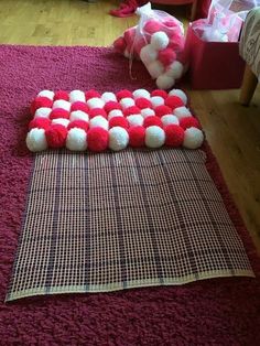 red and white pom - poms laid out on the floor