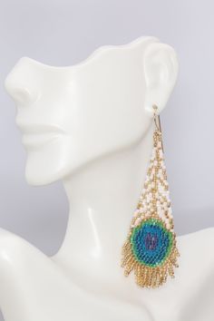 a close up of a mannequin head wearing earrings