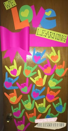 a door decorated with colorful handprints and the words we love learning