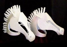 two white horse shaped brushes sitting next to each other