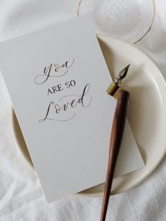 a piece of paper that says you are so loved on it next to a pen