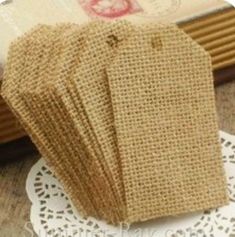 small burlap bags are sitting on a doily