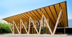 a large wooden structure sitting on top of a gravel field