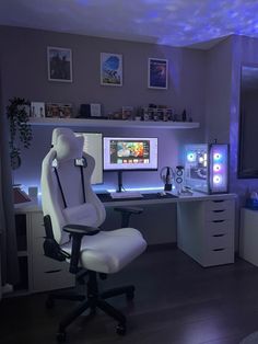 a white chair sitting in front of a computer desk