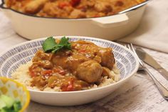 two bowls filled with rice and meat next to a casserole dish on a table