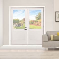 a couch sitting in front of a white door with two glass panels on each side