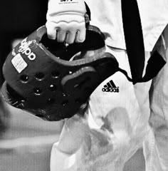 black and white photograph of a man holding a catchers mitt in his right hand