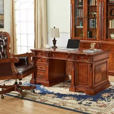 an executive desk with chair and bookcase in a living room next to a window