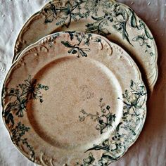 two plates sitting on top of a white table cloth