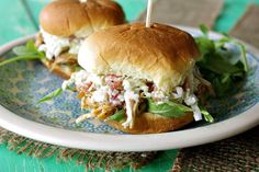 two pulled pork sandwiches on a blue and white plate